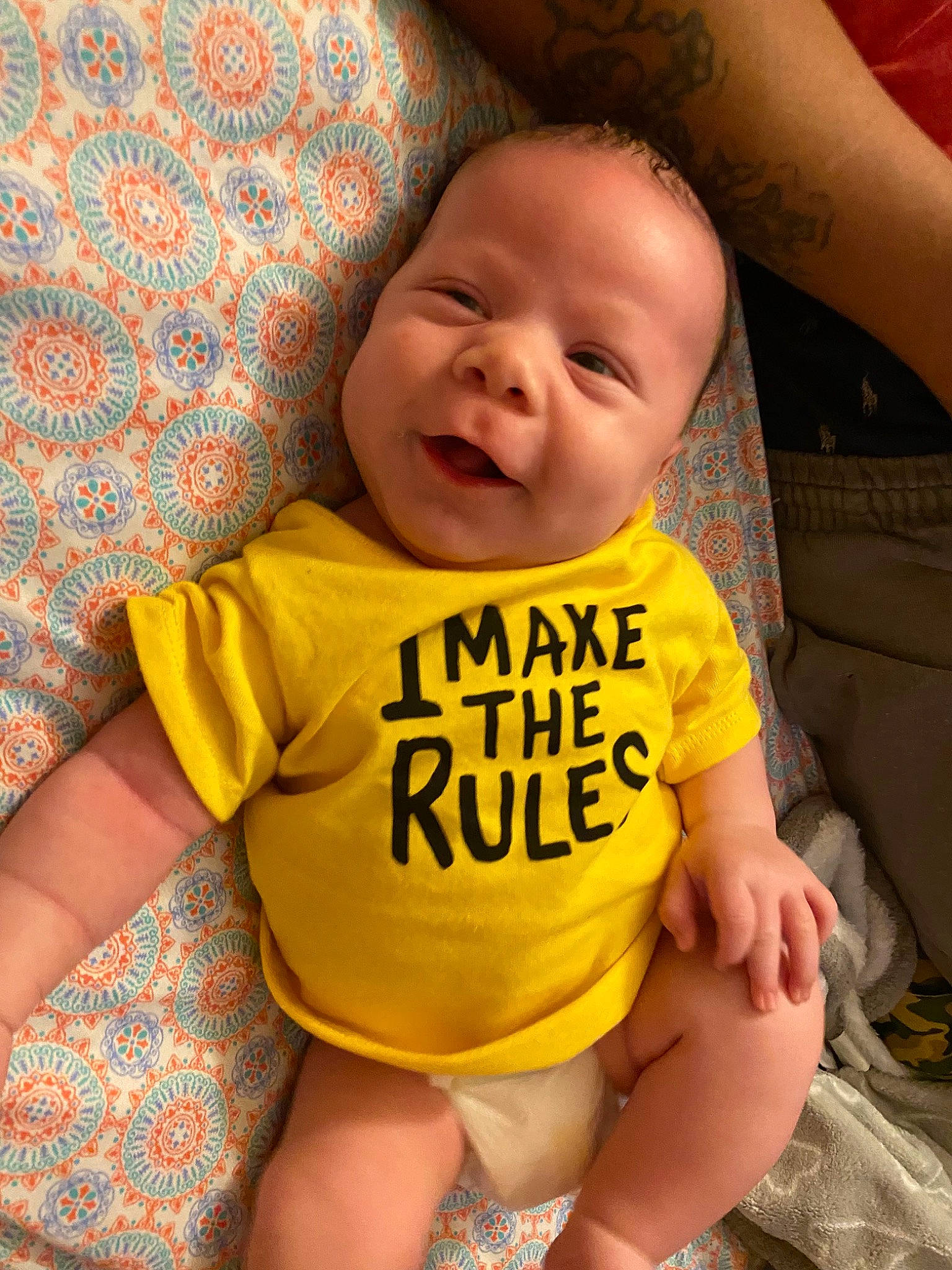 Amari is registered to the contest to win money with this photo: baby, baby_toddler_clothing, cheek, eye, facial_expression, hair, happy, iris, leg, lip, mouth, neck, nose, orange, person, product, skin, sleeve, smile, stomach