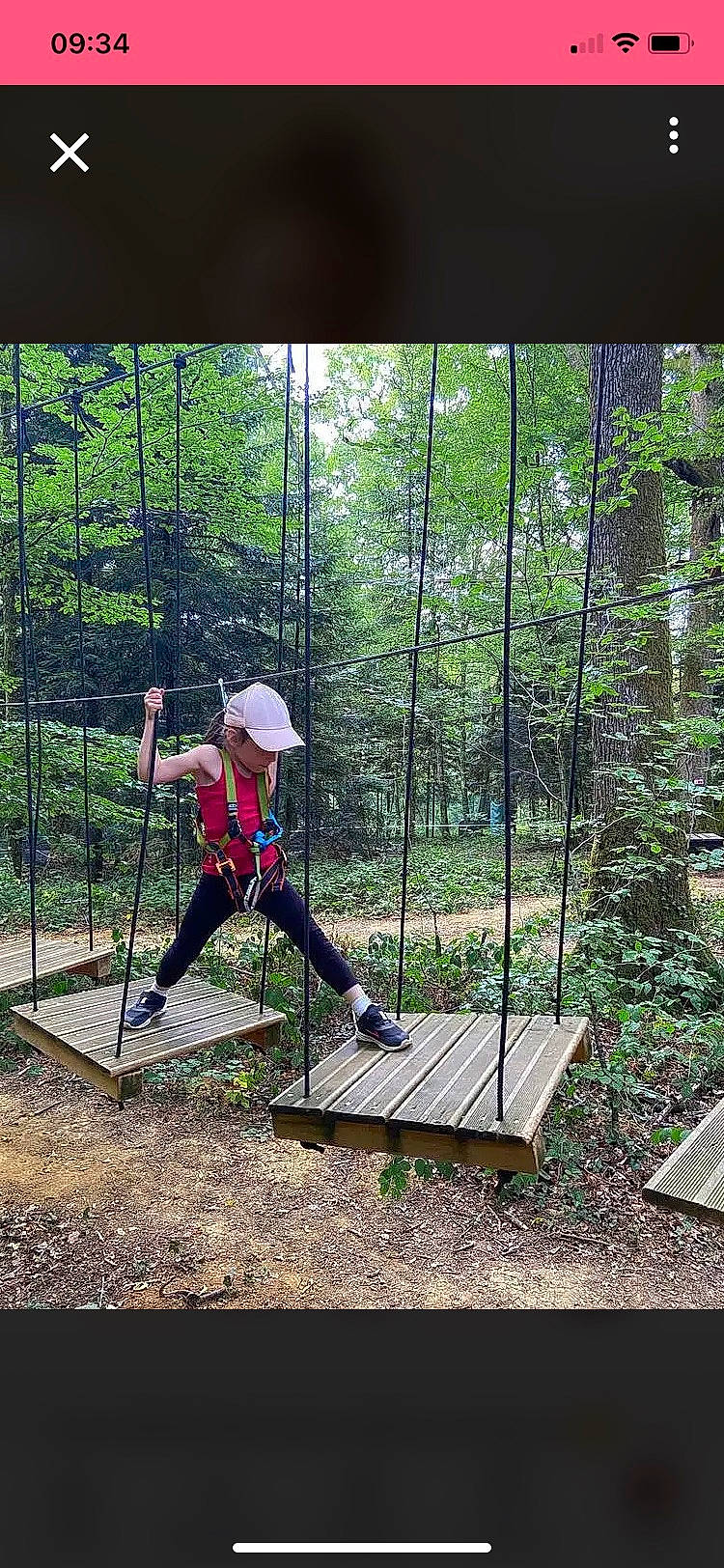 Clara participe au concours pour gagner de l'argent avec cette photo : chain_link_fencing, fence, forest, fun, grass, headwear, landscape, leisure, mesh, net, outdoor_play_equipment, people_in_nature, person, plant, recreation, shade, slope, soil, swing, tree