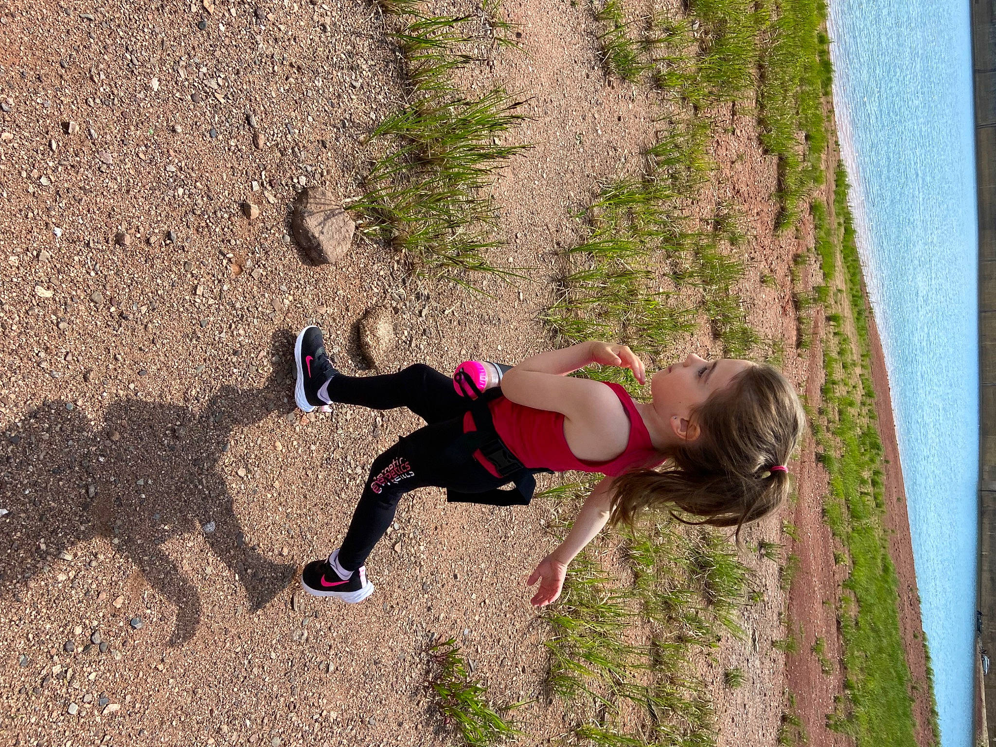 Clara participe au concours pour gagner de l'argent avec cette photo : adventure, asphalt, fun, grass, happy, human_leg, knee, landscape, leisure, magenta, people_in_nature, person, plant, recreation, sand, shadow, soil, thigh, toddler, tree