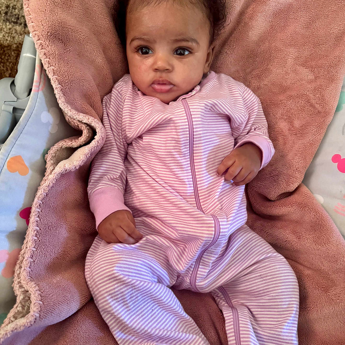 Navia joined the competition — help win amazing prizes! baby, blanket, child, comfort, curly_hair, cute, expression, face, feet, hands, indoor, infant, onesie, pink, plush, portrait, purple_bow, relaxing, soft_texture, striped_clothing