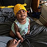 Dream joined the competition — help win amazing prizes! baby, child, bandana, bed, blanket, hand, person, room, storage_bin, furniture, shelf, clothing, floor, indoor, expression, skin, smile, curly_hair, bedroom, holding_hand