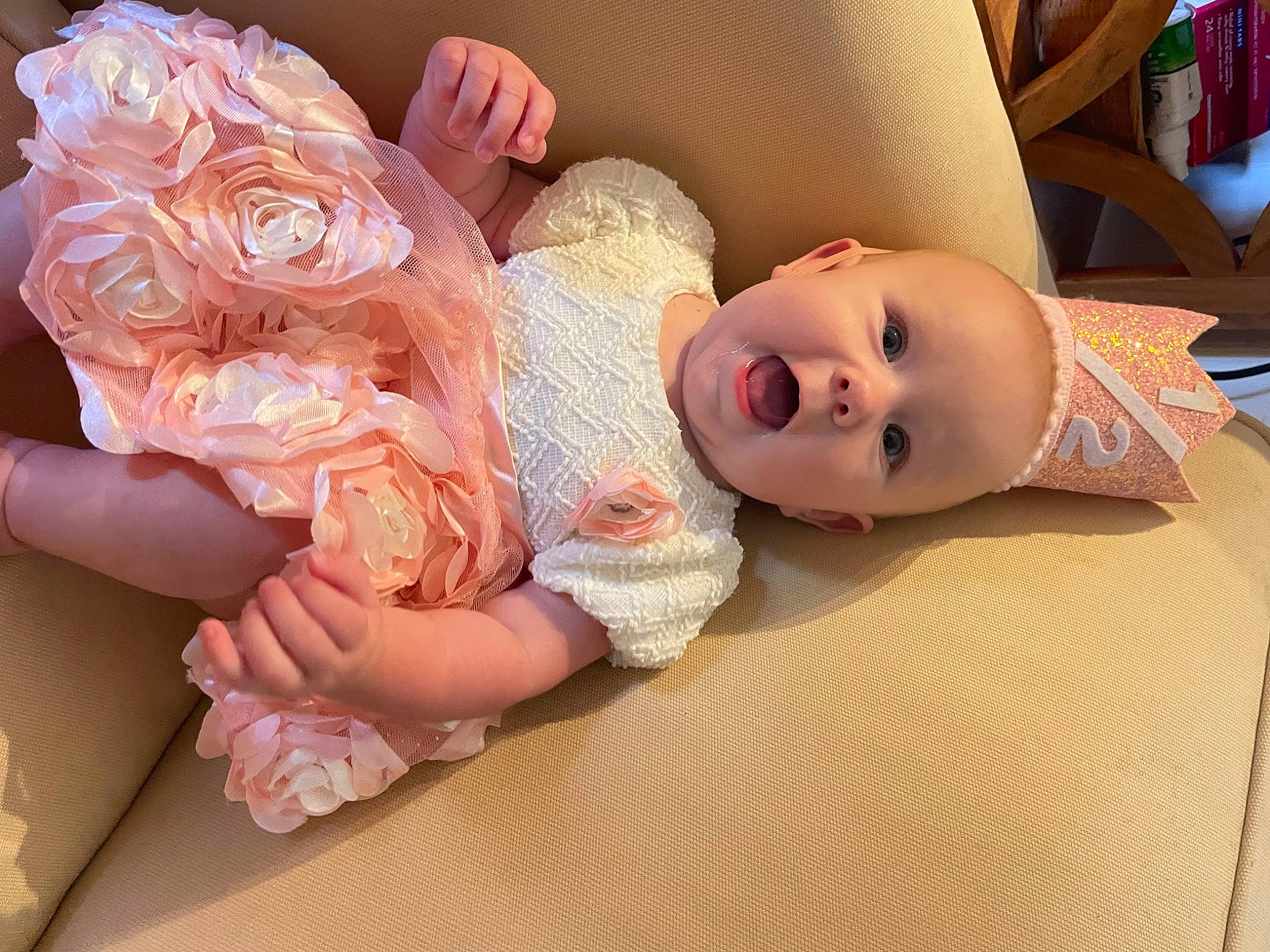 Kayleigh is registered to the contest to win money with this photo: baby, baby_toddler_clothing, cheek, comfort, dress, eye, eyelash, finger, head, headgear, headpiece, human_body, iris, lip, person, pink, product, skin, smile, toddler