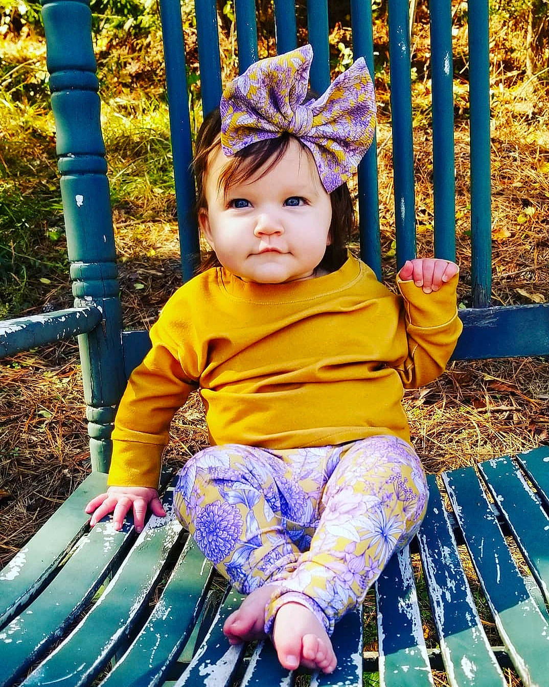 Arizona is registered to the contest to win money with this photo: autumn, baby, child, child_model, fun, happy, headwear, leaf, leisure, outdoor_play_equipment, people_in_nature, person, plant, play, playground, public_space, recreation, smile, toddler, tree
