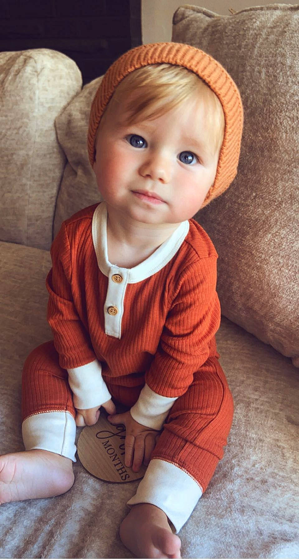 Austin is registered to the contest to win money with this photo: baby, baby_toddler_clothing, blond, cap, cheek, child, comfort, iris, knee, leg, lip, nose, outerwear, person, sitting, skin, sleeve, sock, thigh, toddler