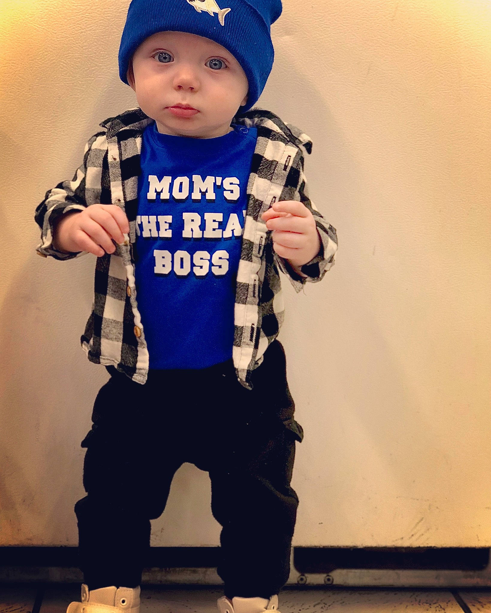 Cannon is registered to the contest to win money with this photo: baby, baby_toddler_clothing, blue, clothing, face, flash_photography, gesture, happy, headgear, headwear, luggage_and_bags, outerwear, person, personal_protective_equipment, sleeve, sports_gear, sportswear, standing, street_fashion, t_shirt