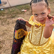 Rheagan is registered to the contest to win money with this photo: bodypart, child, clothing, costume, cream, dress, face, female, finger, food, formalwear, girl, grass, hand, head, person, photography, plant, portrait, sweets