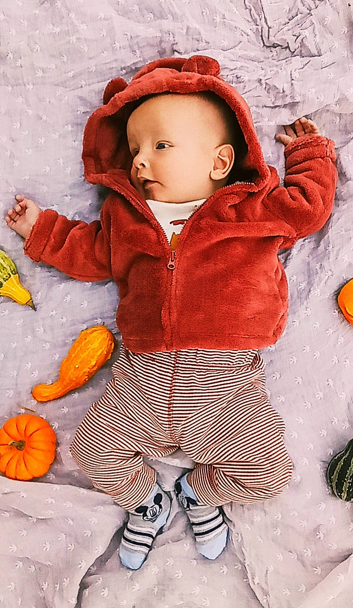 Jerry is registered to the contest to win money with this photo: arm, baby, baby_toddler_clothing, calabaza, cheek, child, cucurbita, eye, gourd, happy, headgear, orange, organ, outerwear, pattern, person, pumpkin, sleeve, textile, toddler