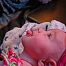 Hazelmarie joined the competition — help win amazing prizes! baby, blanket, child, colorful, cozy, cute, expression, face, fuzzy_texture, headband, indoor, infant, pink_clothing, playful, portrait, resting, side_profile, soft_lighting, tongue, young_child