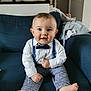 Maël a rejoint le concours — aidez-le/la à gagner de superbes lots ! accessories, animal, baby, bird, bodypart, clothing, couch, face, finger, formalwear, furniture, glove, hand, head, pants, person, photography, portrait, sitting, tie