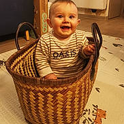 Maël participe au concours pour gagner de l'argent avec cette photo : baby, basket, bed, box, clothing, crib, face, footwear, furniture, hardwood, head, infantbed, pants, person, photography, portrait, shoe, shoppingbasket, sitting, wood