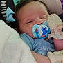 baby, pacifier, blanket, mittens, bow, sleepy, closeup, face, infant, soft, floral, blue, cute, child, cozy, comfort, resting, indoors, person, newborn