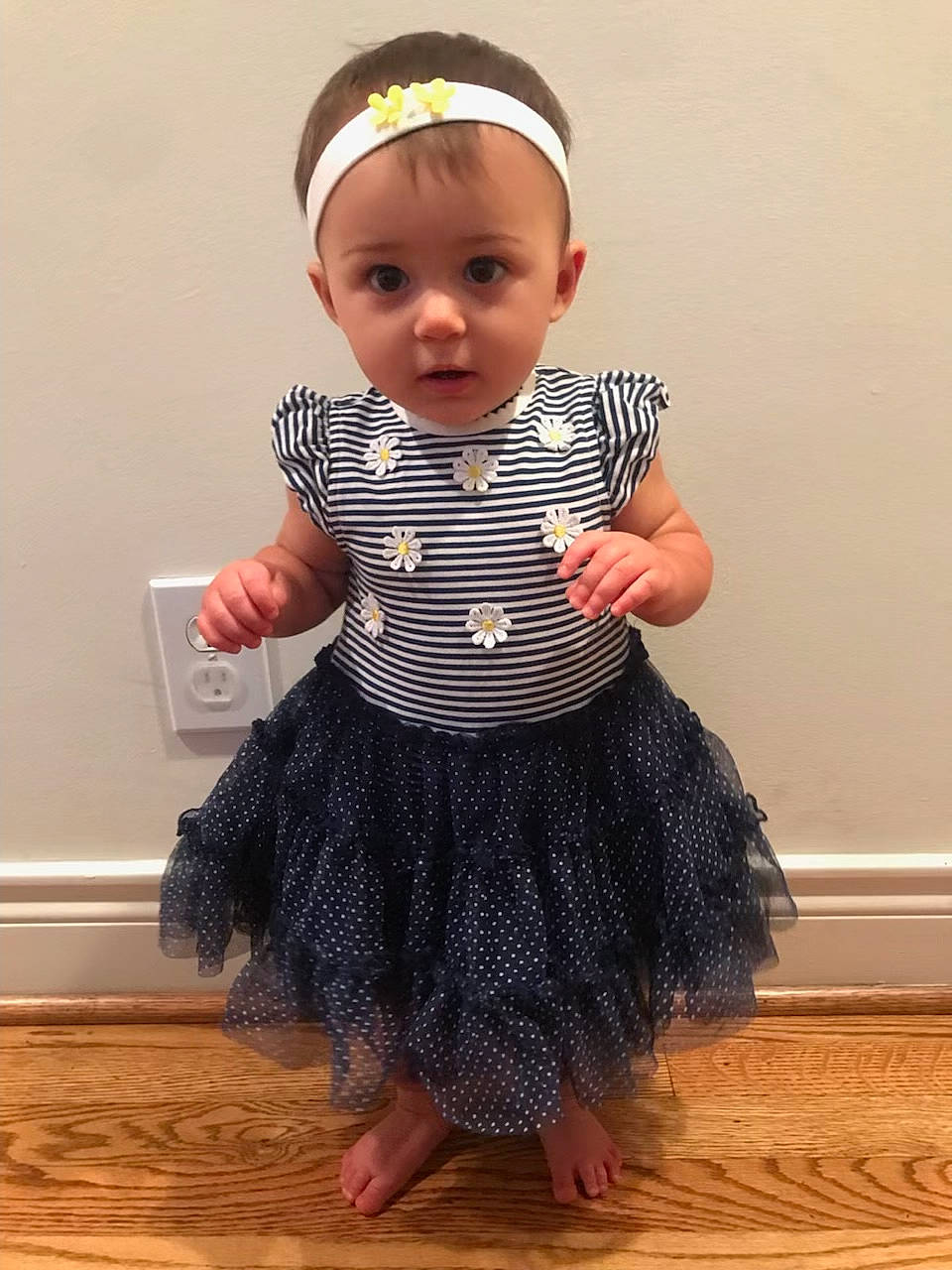 Sage joined the competition — help win amazing prizes! baby, baby_toddler_clothing, child, child_model, cocktail_dress, costume, costume_accessory, day_dress, embellishment, fashion_accessory, flooring, hardwood, one_piece_garment, pattern, person, ruffle, sitting, sleeve, toddler, wood