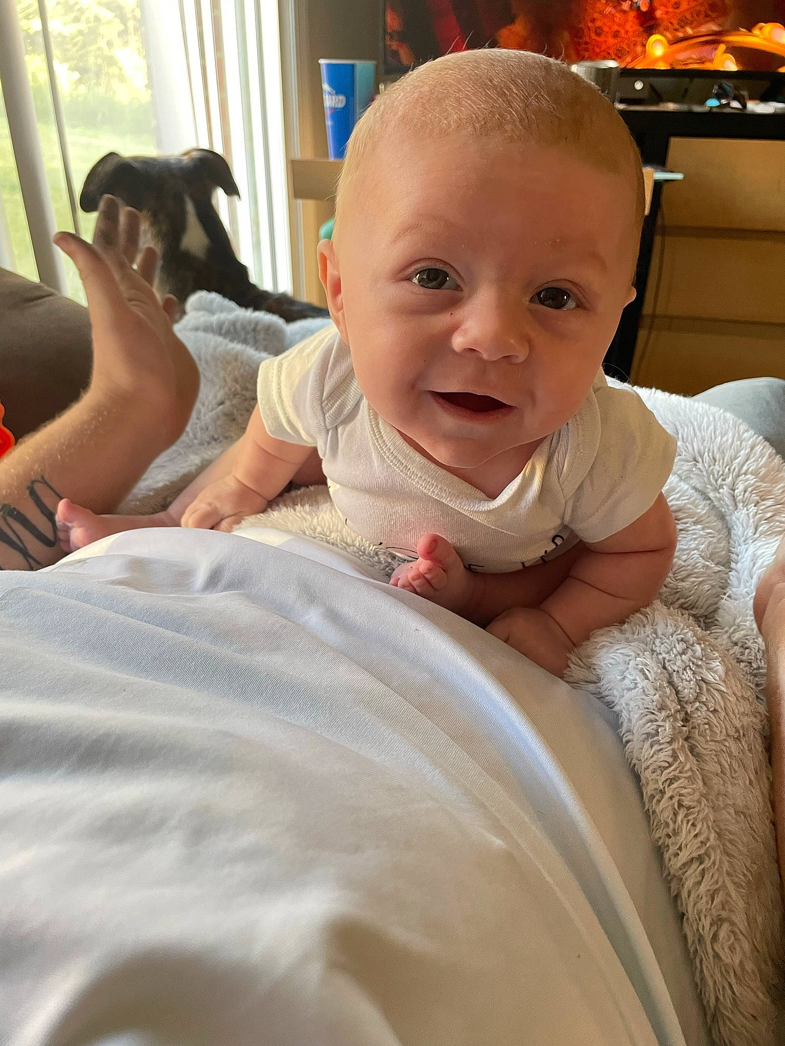 Kaine joined the competition — help win amazing prizes! arm, baby, baby_toddler_clothing, child, comfort, event, facial_expression, finger, fun, hand, happy, head, linens, mouth, person, shoulder, sitting, skin, smile, thumb