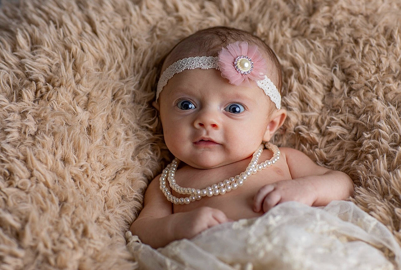 Saylor is registered to the contest to win money with this photo: baby, baby_toddler_clothing, child, dress, embellishment, eye, eyelash, face, flash_photography, grass, happy, headband, headgear, headpiece, headwear, iris, jewellery, person, skin, textile