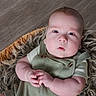 baby, infant, face, eyes, hands, clothing, romper, basket, fur, texture, wooden_floor, closeup, portrait, cute, child, newborn, skin, expression, indoor, soft_lighting