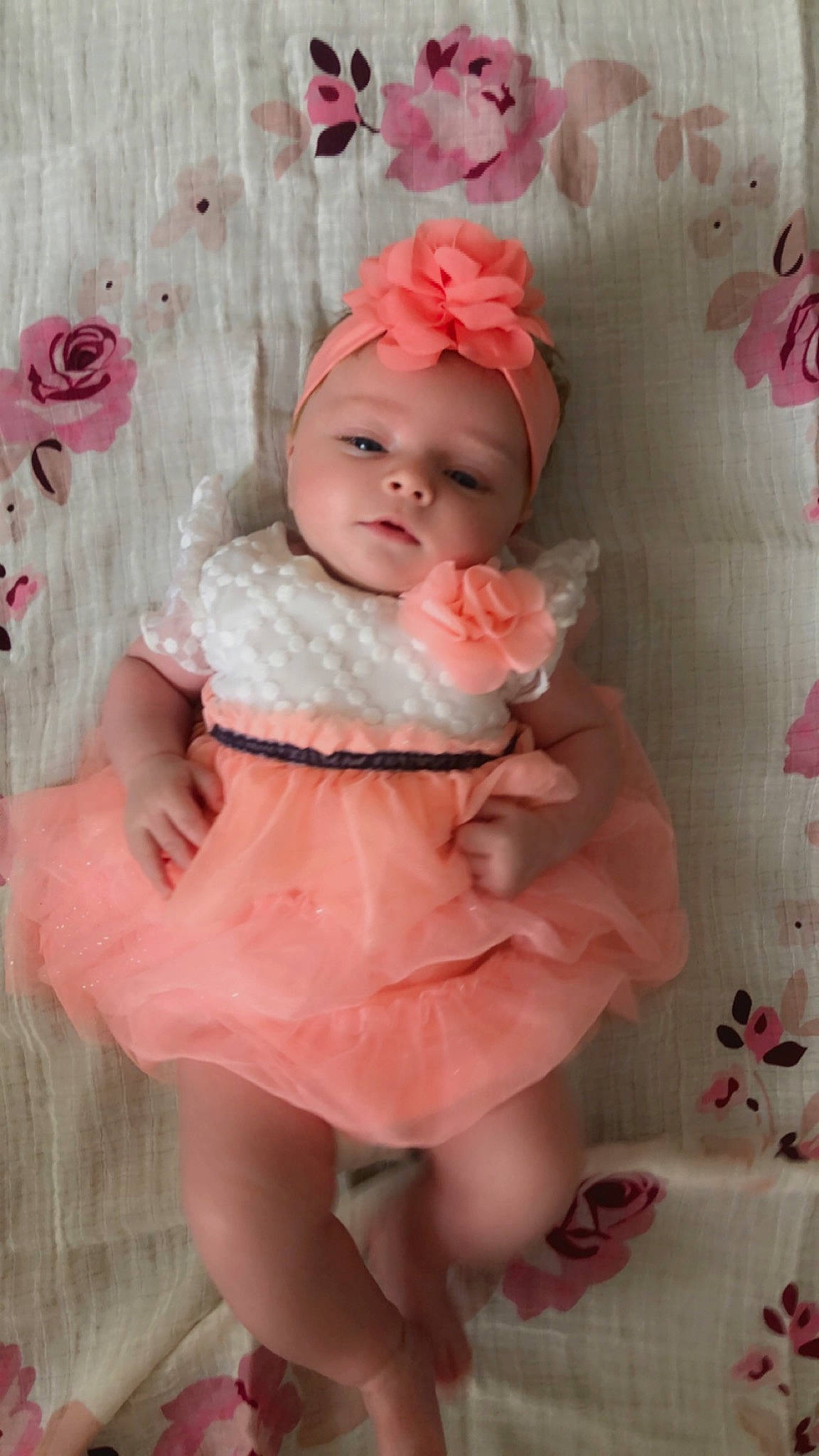 Skylar is registered to the contest to win money with this photo: baby, baby_toddler_clothing, cheek, child, dress, face, happy, headgear, headwear, human_body, lip, magenta, pattern, peach, person, petal, pink, skin, sleeve, smile