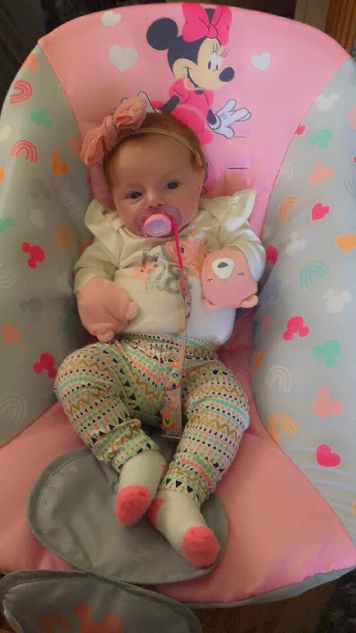 Skylar is registered to the contest to win money with this photo: baby, baby_products, baby_toddler_clothing, cheek, child, comfort, foot, human_body, human_leg, knee, person, pink, product, sitting, skin, sock, stuffed_toy, textile, thigh, toddler
