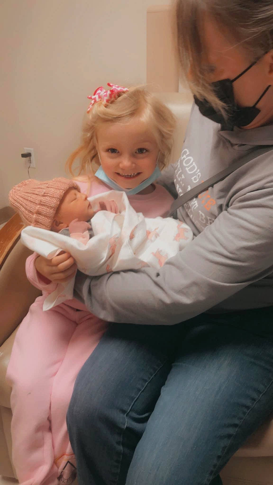 Macy is registered to the contest to win money with this photo: baby, comfort, dress, eye, face, facial_expression, gesture, hair, hairstyle, happy, head, headwear, human_body, iris, joint, joy, leg, mouth, person, shoulder