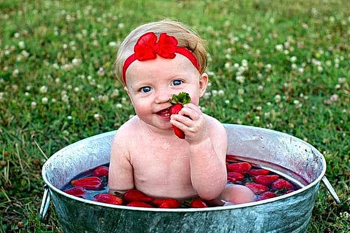 Macy joined the competition — help win amazing prizes! baby, bowl, child, fruit, grass, green, happy, headwear, ingredient, lip, natural_foods, people_in_nature, person, petal, photograph, plant, recreation, red, rose_family, rose_order