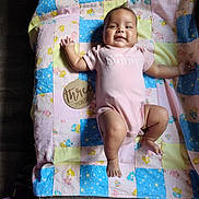 Glorianna joined the competition — help win amazing prizes! baby, infant, pink_onesie, patchwork_blanket, care_bears, wooden_sign, three_months, smiling, lying_down, child, cute, soft_light, fabric, floor, happy, indoors, person, small_child, blanket, skin