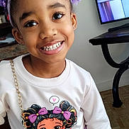 Destiny joined the competition — help win amazing prizes! child, girl, smiling, indoor, purple_bow, headband, sweatshirt, cartoon_print, purse, television, news_anchor, floor, wooden_floor, table, happy, person, casual_clothing, portrait, cute, standing