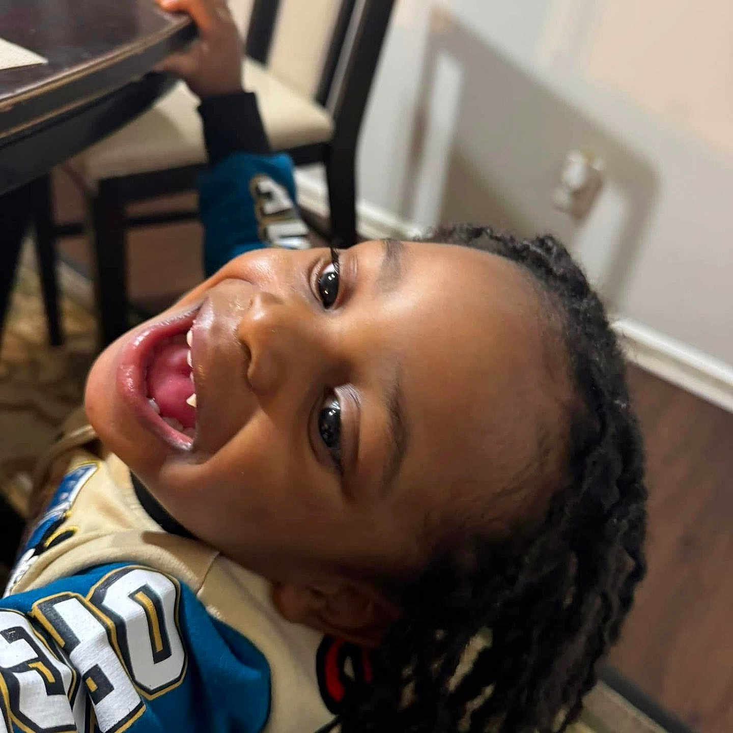 Kyng joined the competition — help win amazing prizes! braided_hair, casual, chair, child, clothing, expression, face, fun, hand, happy, home, indoor, joy, person, portrait, rug, smiling, table, wooden_floor, young