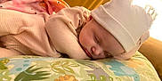 Defiance is registered to the contest to win money with this photo: baby, sleeping, hat, blanket, pillow, animal_print, cute, child, indoors, cozy, soft, peaceful, rest, nap, bedtime, infant, face, headwear, comfort, warm