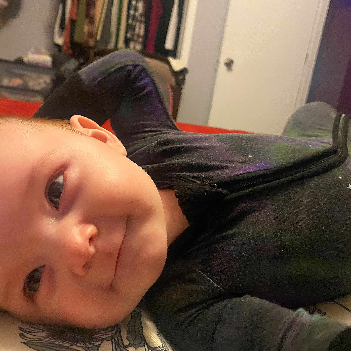 Defiance is registered to the contest to win money with this photo: baby, bed, blanket, child, clothing, cozy, cute, face, furniture, happy, head, indoors, infant, lying_down, person, portrait, room, sleepwear, smiling, young