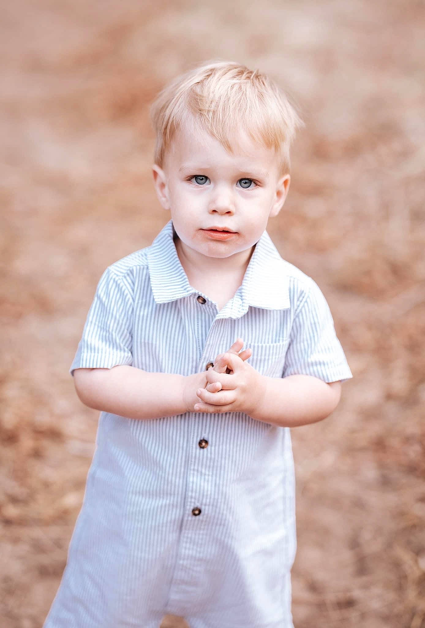 Zaidyn is registered to the contest to win money with this photo: baby_toddler_clothing, button, child, collar, dress_shirt, flash_photography, gesture, grass, happy, pattern, people_in_nature, person, plant, shirt, skin, sleeve, standing, t_shirt, toddler, tree