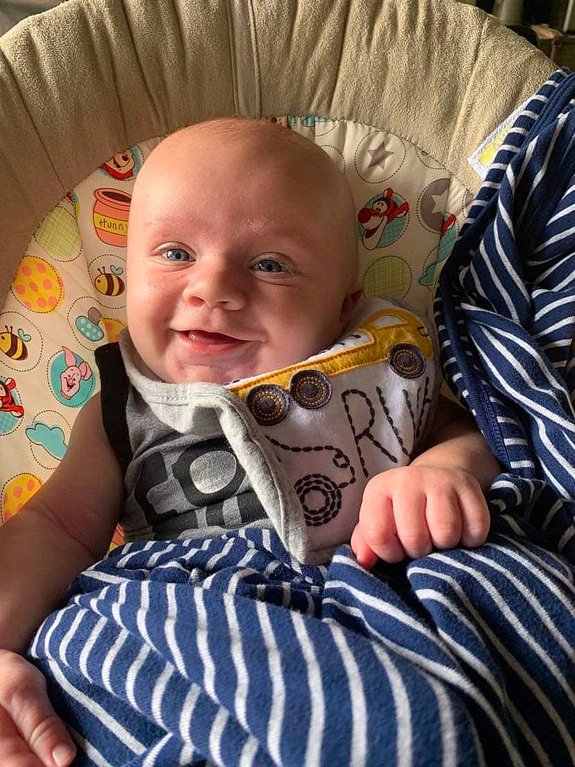 Andrew is registered to the contest to win money with this photo: baby, baby_products, baby_toddler_clothing, cheek, child, comfort, face, finger, fun, happy, linens, mouth, pattern, person, room, sitting, sleeve, smile, t_shirt, toddler