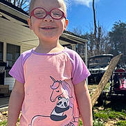 Riley joined the competition — help win amazing prizes! child, glasses, smiling, outdoor, sunny, unicorn, panda, leopard, shirt, grass, house, tree, daytime, person, happy, casual, portrait, nature, playful, young