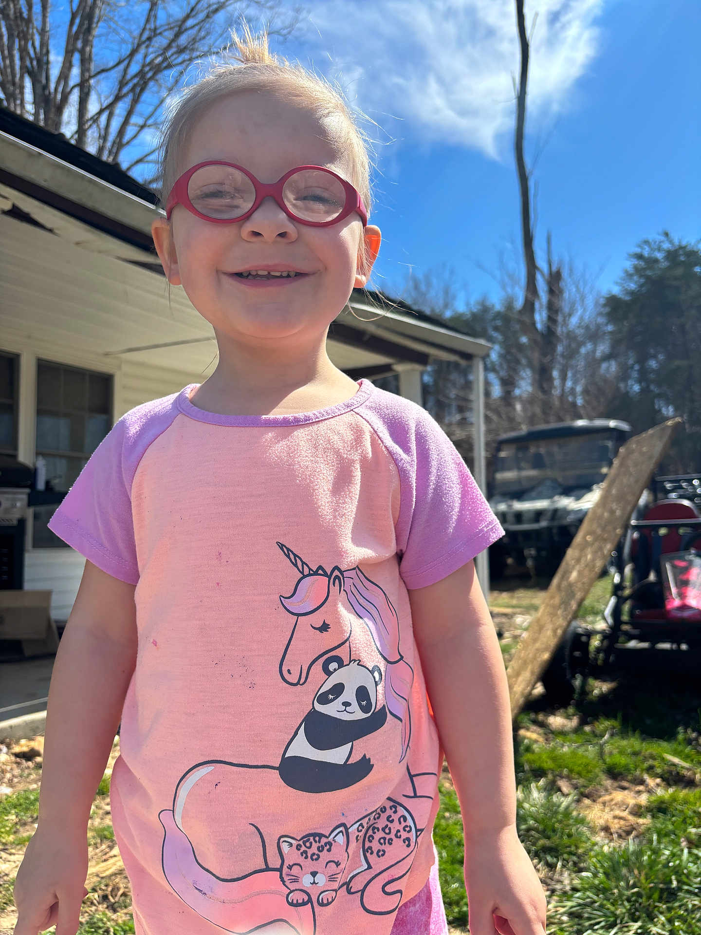 Riley joined the competition — help win amazing prizes! child, glasses, smiling, outdoor, sunny, unicorn, panda, leopard, shirt, grass, house, tree, daytime, person, happy, casual, portrait, nature, playful, young
