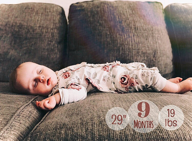 Zivah is registered to the contest to win money with this photo: baby, baby_toddler_clothing, bedding, child, comfort, couch, eye, flash_photography, flooring, fur, grass, happy, human_leg, linens, lip, person, sitting, skin, textile, toddler