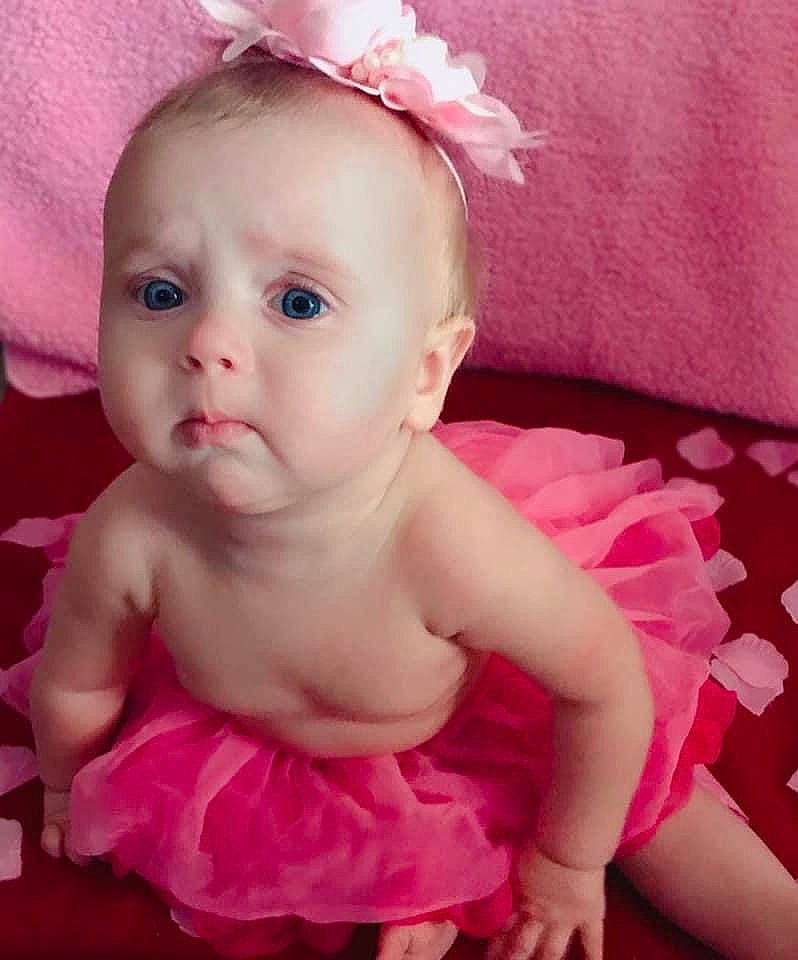 Zivah is registered to the contest to win money with this photo: baby, baby_toddler_clothing, dress, ear, face, finger, happy, headband, headgear, headpiece, jewellery, lip, magenta, person, petal, pink, purple, skin, textile, toddler