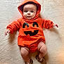 Gabriel joined the competition — help win amazing prizes! baby, infant, orange_hoodie, pumpkin_costume, cute, smiling_face, soft_blanket, lying_down, wide_eyes, brown_shoes, cozy, festive, halloween, child, apparel, hood, legs, hands, indoors, portrait