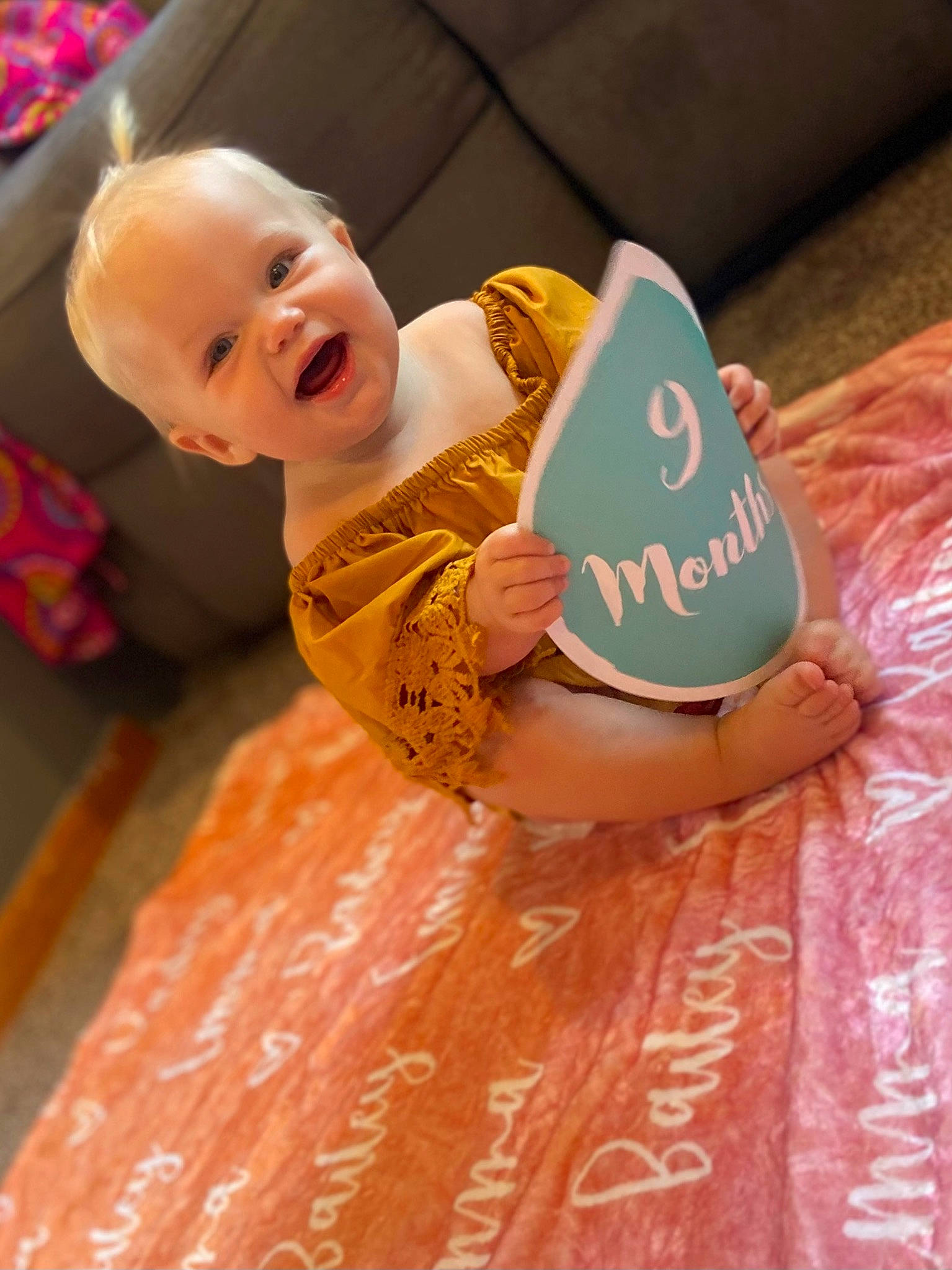 Bailey joined the competition — help win amazing prizes! baby, baby_products, baby_toddler_clothing, cheek, child, comfort, finger, flooring, fun, happy, head, orange, person, pink, play, room, sitting, skin, smile, toddler
