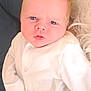 Harland joined the competition — help win amazing prizes! adult_hand, baby, blanket, blond_hair, blue_eyes, child, closeup, couch, expression, face, fuzzy_blanket, hand, indoor, infant, onesie, person, portrait, soft_lighting, watch, white_clothing