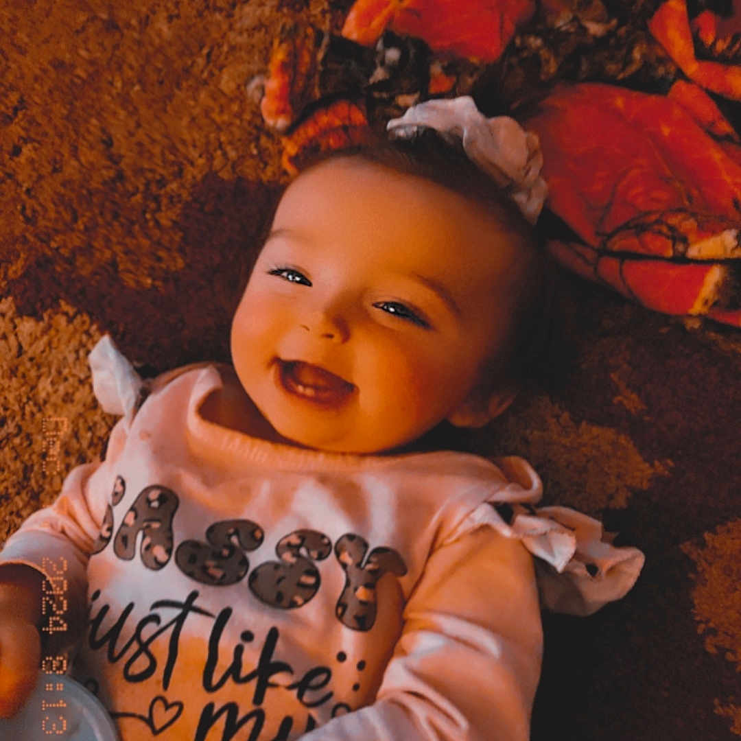 Cheyenne joined the competition — help win amazing prizes! baby, babylaughing, bodypart, clothing, couch, face, finger, furniture, hand, happy, head, laughing, mouth, person, photography, portrait, sitting, smile, t_shirt, toy