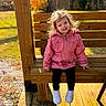 autumn, bench, casual_clothing, child, daylight, fall_leaves, grass, happy, nature, outdoor, person, pink_jacket, portrait, smiling, sunlight, toddler, tree, white_sneakers, wood, wooden_bench