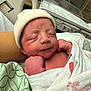 Nestor is registered to the contest to win money with this photo: newborn, baby, infant, hospital, blanket, hat, sleeping, person, bed, swaddled, skin, hand, face, resting, medical, healthcare, closeup, cute, peaceful, indoors