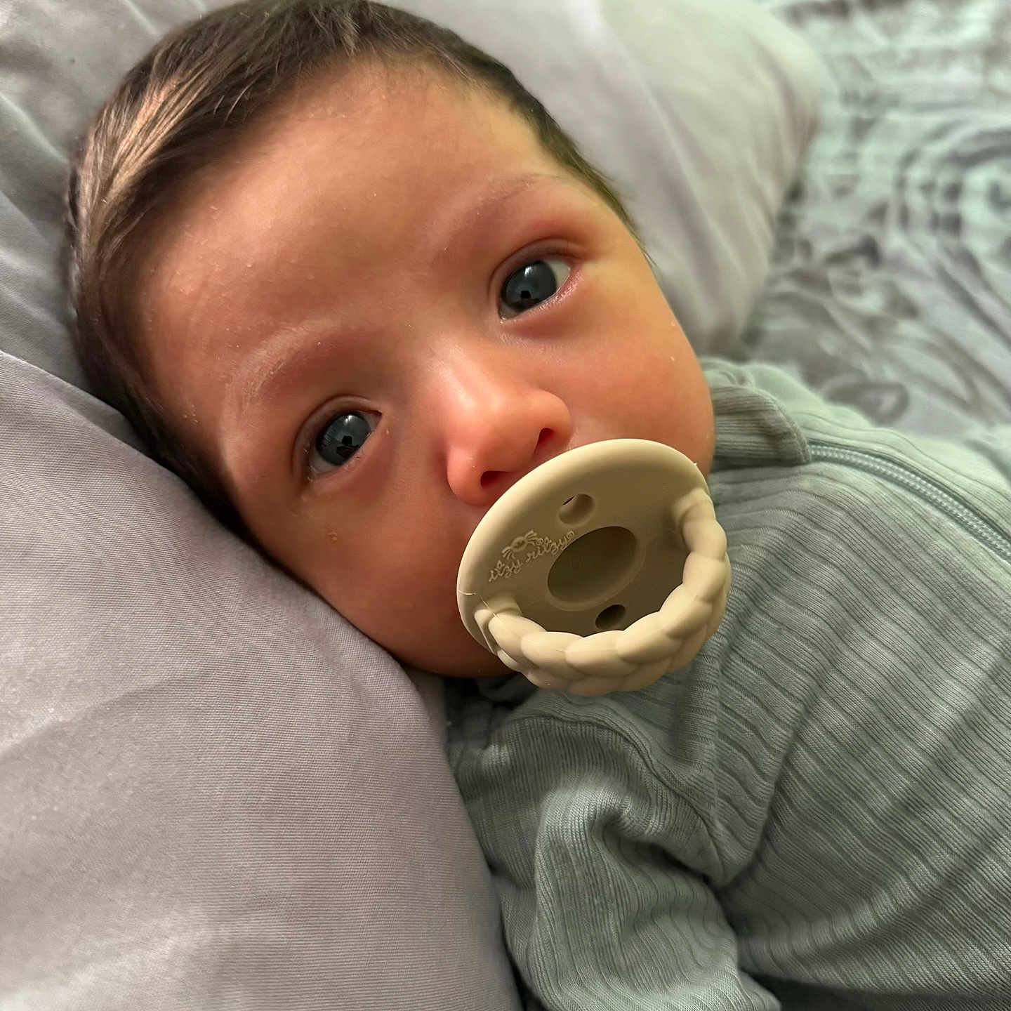 Nestor joined the competition — help win amazing prizes! baby, bed, blanket, blue_eyes, child, close_up, cute, face, head, indoors, infant, lying_down, pacifier, pillow, portrait, resting, ribbed_clothing, skin, soft_light, young