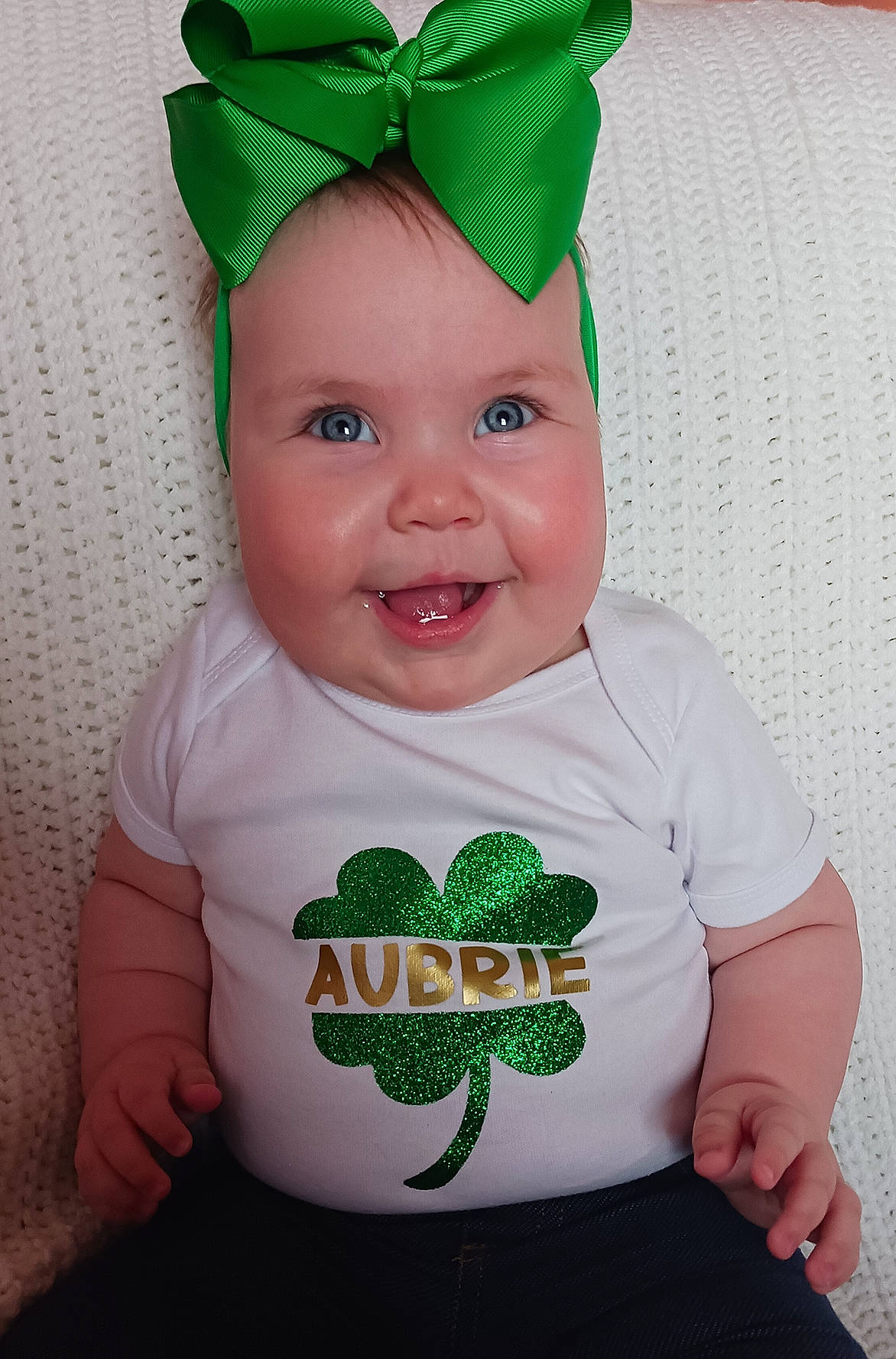 Aubrie is registered to the contest to win money with this photo: baby, baby_products, baby_toddler_clothing, cap, child, clothing, costume_hat, fashion_accessory, font, green, happy, head, headgear, joy, pattern, person, pink, sleeve, smile, t_shirt