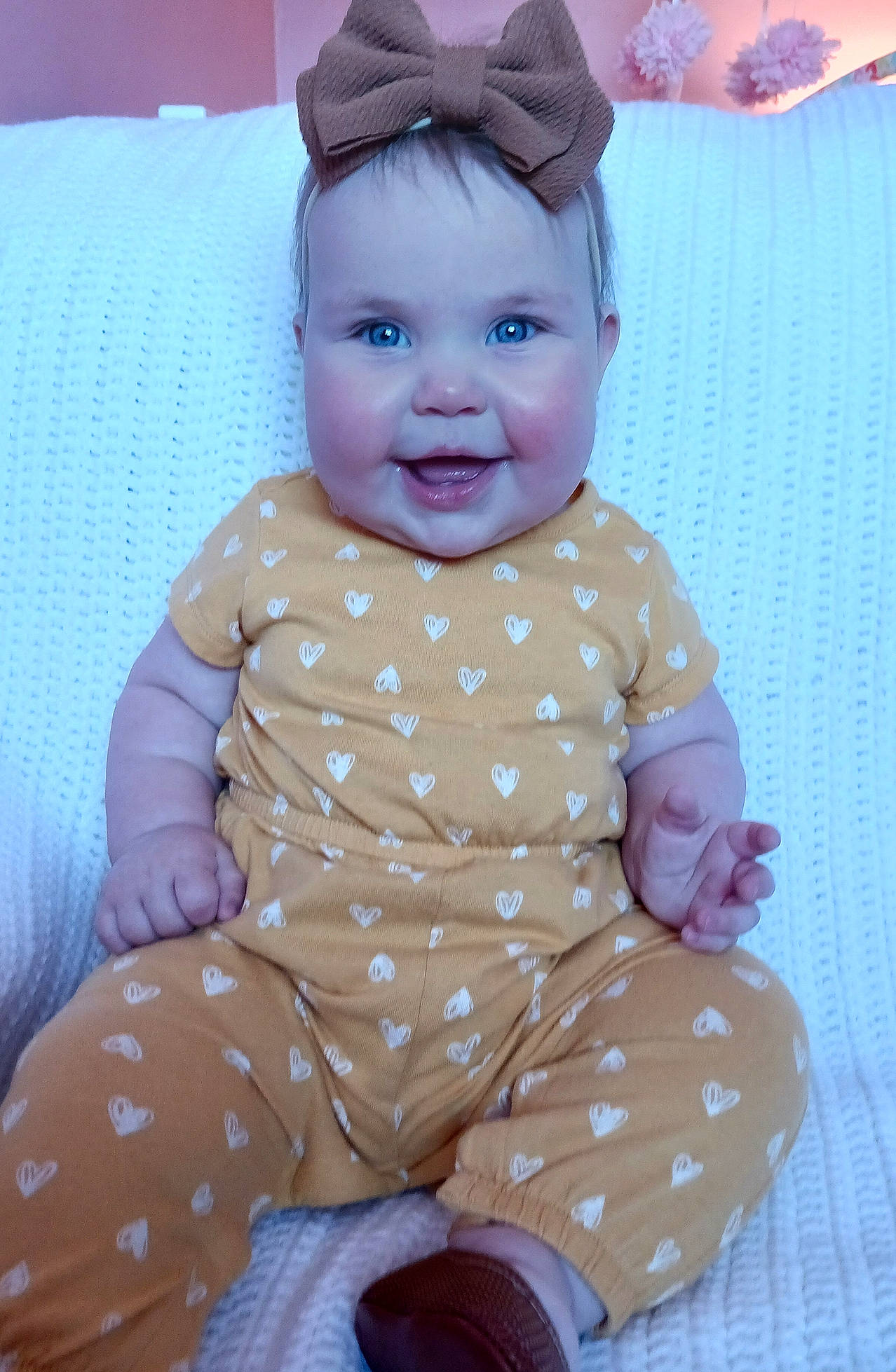 Aubrie joined the competition — help win amazing prizes! baby, baby_laughing, baby_products, baby_toddler_clothing, cheek, child, chin, comfort, happy, head, joy, linens, pattern, person, pink, sitting, skin, sleeve, smile, textile