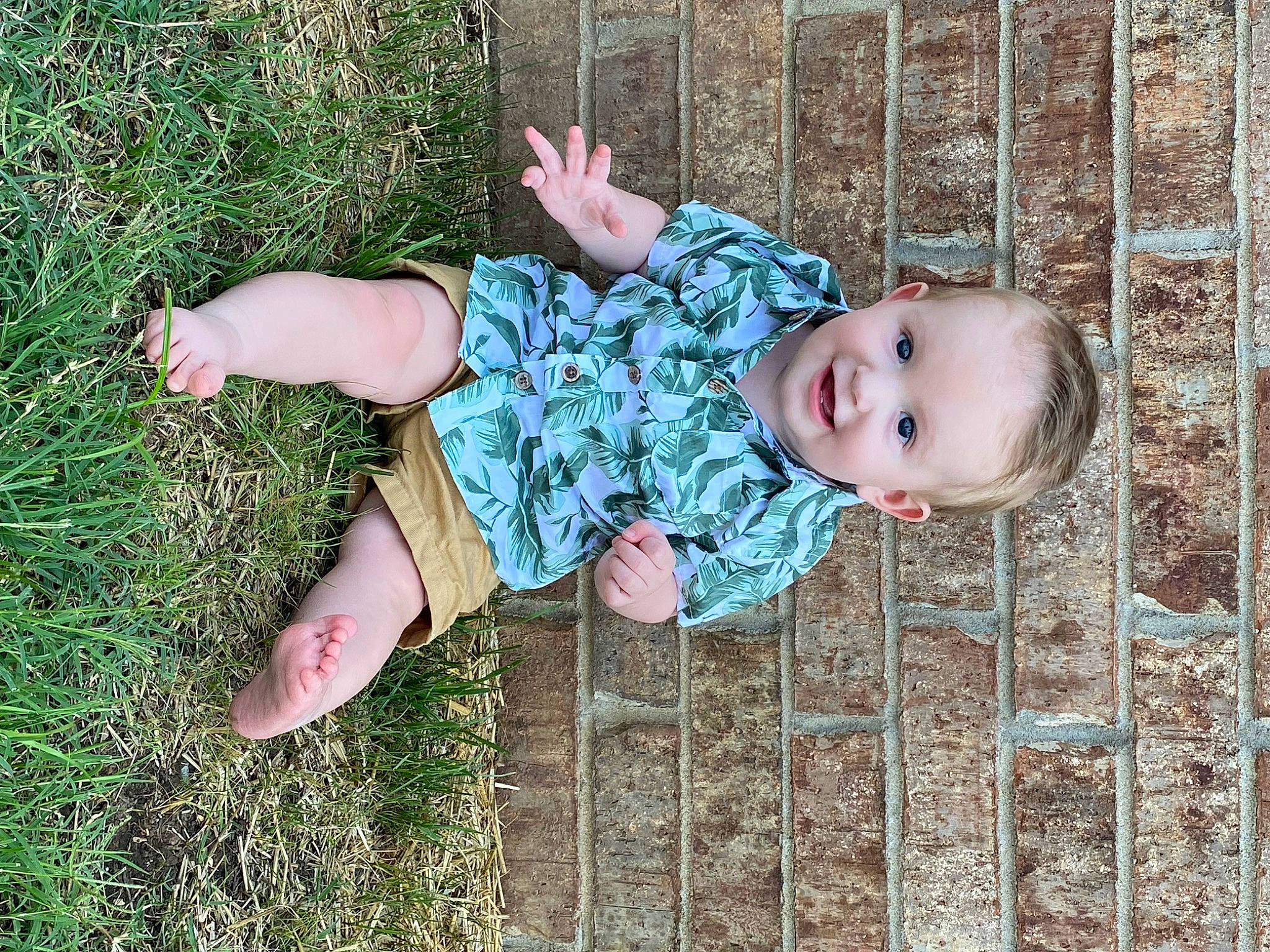 Kash Ray is registered to the contest to win money with this photo: baby, baby_toddler_clothing, child, clothing, fence, fun, grass, happy, human_body, joy, leg, leisure, pattern, people_in_nature, person, plant, sitting, skin, smile, toddler