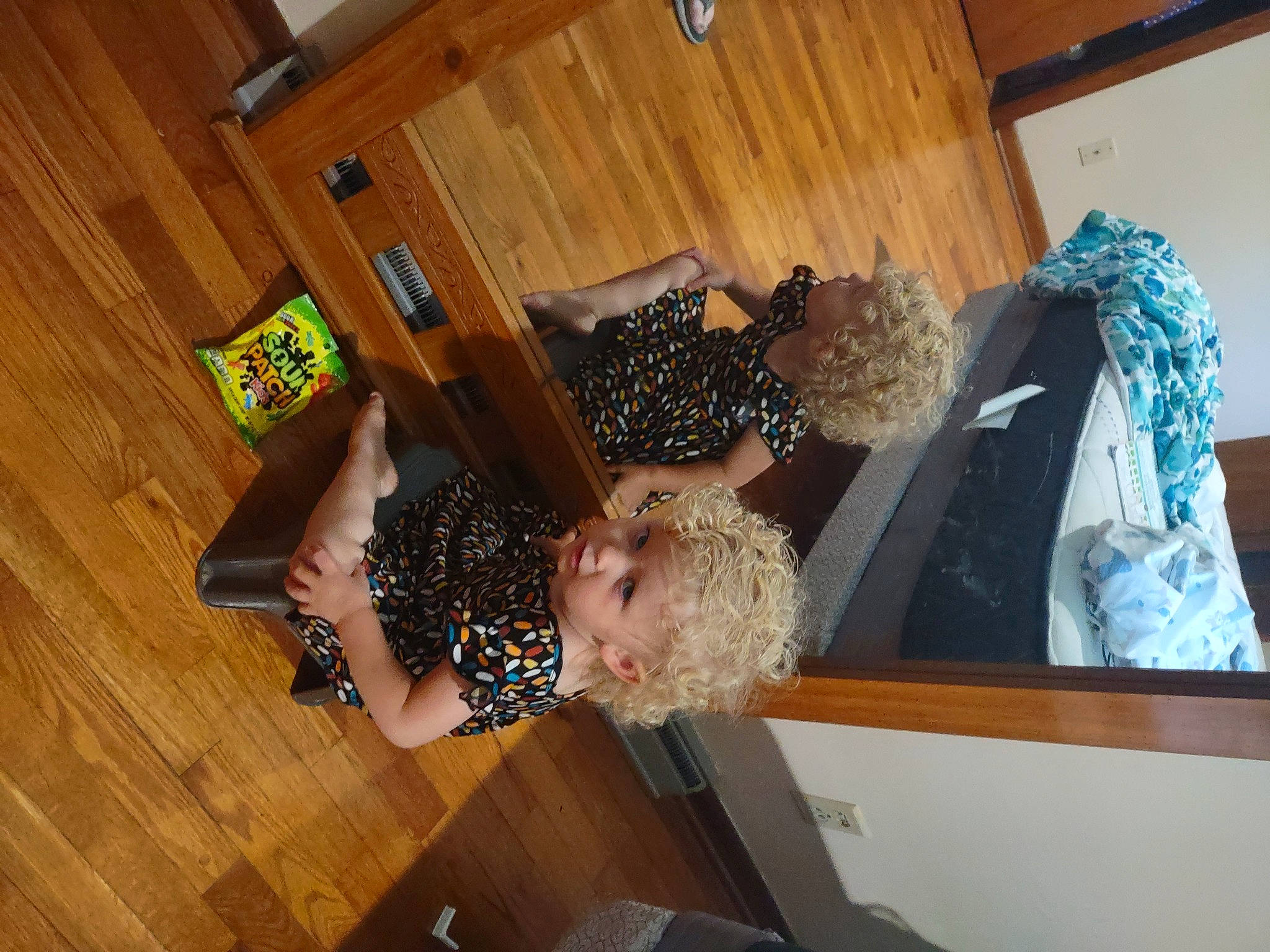 Journey is registered to the contest to win money with this photo: cabinetry, chest_of_drawers, comfort, dress, flooring, hardwood, house, interior_design, laminate_flooring, pattern, person, plywood, room, shelf, thigh, toddler, tree, varnish, wood, wood_flooring