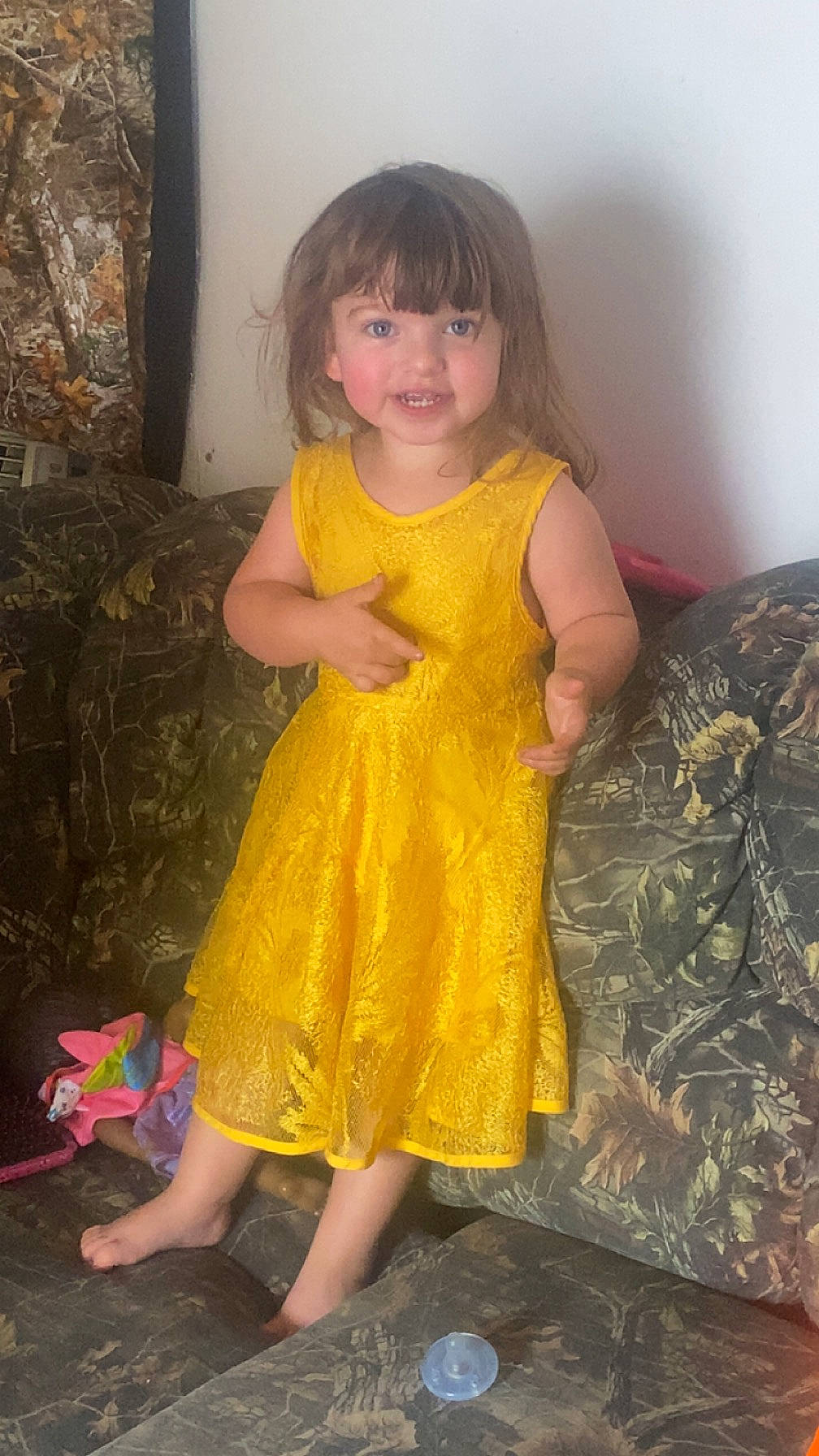 Raelynn is registered to the contest to win money with this photo: baby_toddler_clothing, dress, eye, face, facial_expression, fawn, fun, hair, hairstyle, hand, head, human, iris, leg, person, pink, skin, sleeve, smile, textile