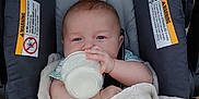 Jax joined the competition — help win amazing prizes! baby, infant, car_seat, blanket, bottle, milk, cute, child, blue_eyes, soft, cozy, indoors, clothing, feeding, person, baby_hair, seat, comfort, rest, portrait