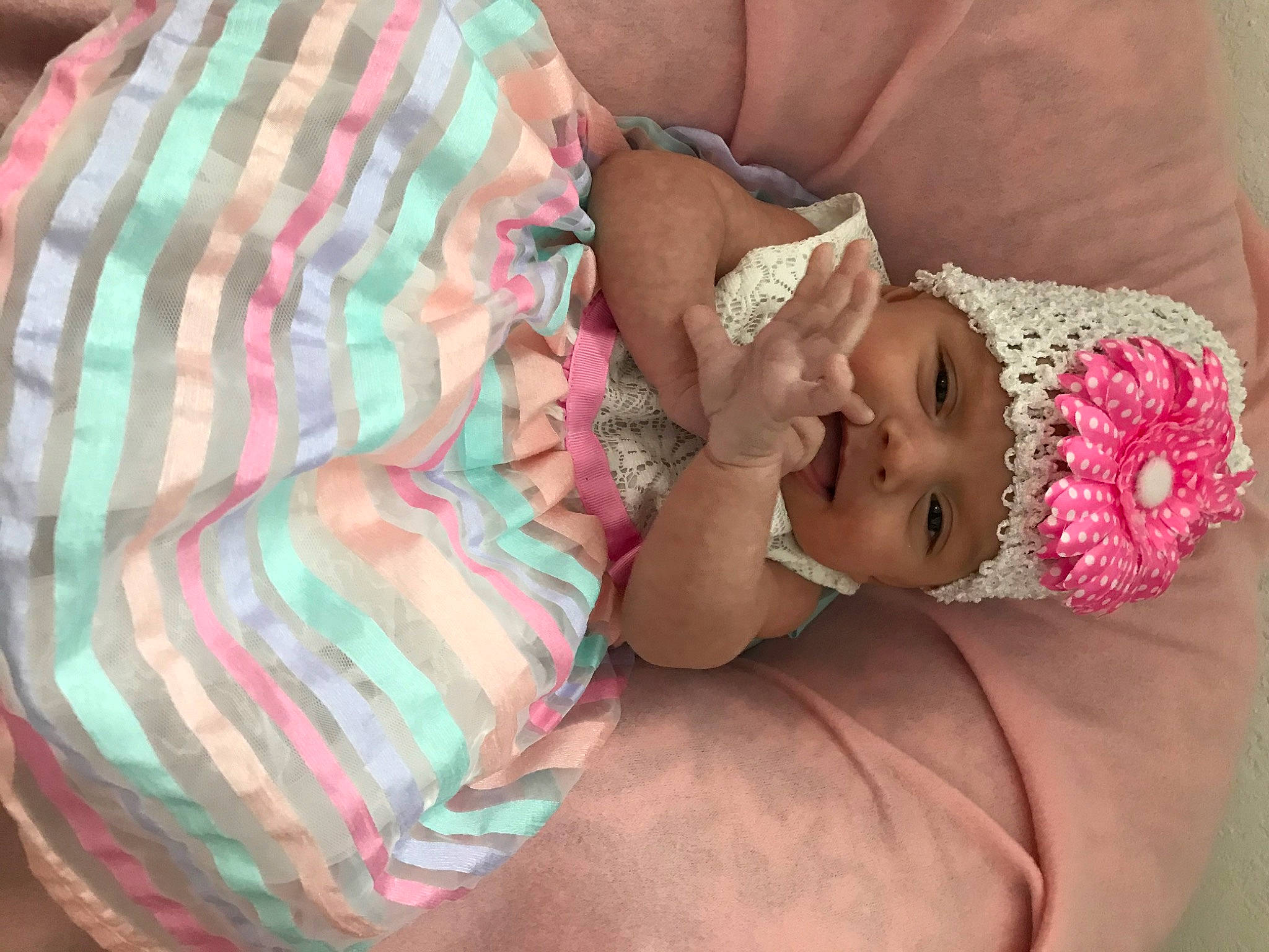 Amora is registered to the contest to win money with this photo: abdomen, baby, baby_products, baby_sleeping, baby_toddler_clothing, cheek, child, comfort, happy, head, headwear, linens, mouth, nail, pattern, person, pink, plaid, skin, tartan