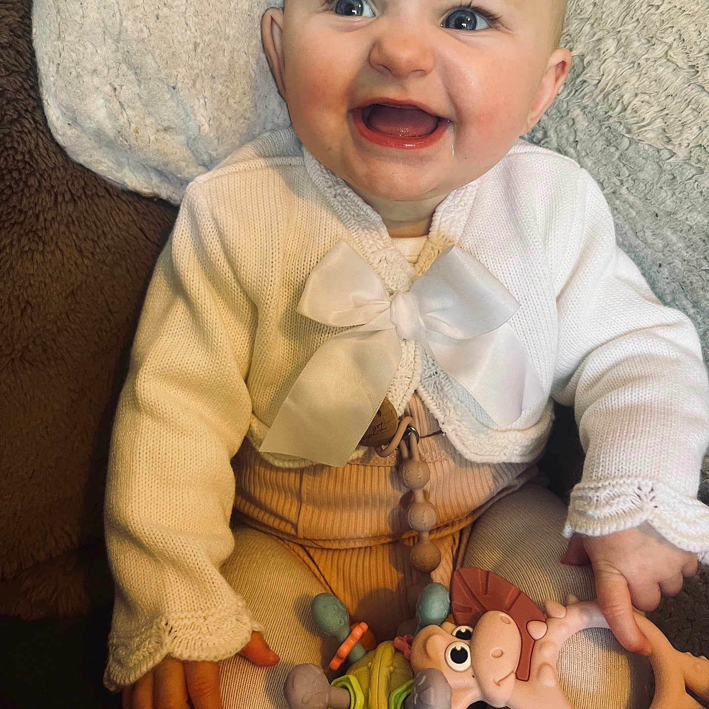 Lilah-Rose joined the competition — help win amazing prizes! accessories, baby, babylaughing, clothing, costume, couch, face, furniture, happy, head, jewelry, laughing, necklace, pants, person, photography, portrait, sitting, smile, toy