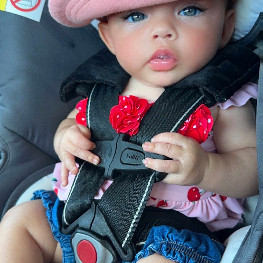 Aria is registered to the contest to win money with this photo: accessories, baby, baseballcap, belt, bodypart, cap, car, clothing, face, finger, hand, hat, head, person, photography, portrait, sunhat, toy, transportation, vehicle